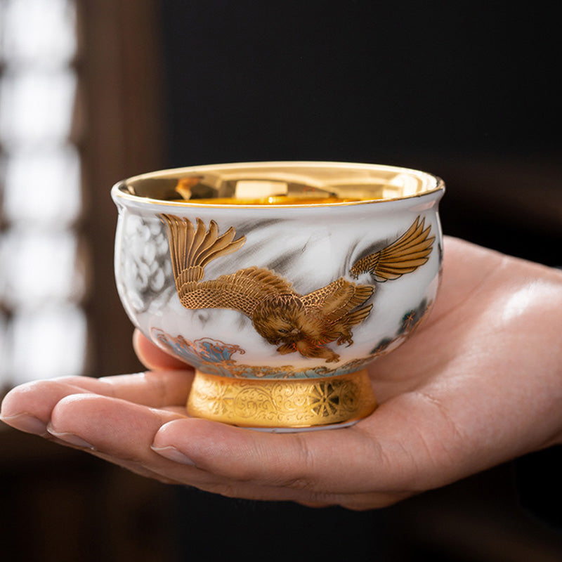 36afd6f1a35c38f72f039fea8c5bf0f5 Buddha Stones Golden Eagle Auspicious Dragon Sun Ocean Waves Gilt Ceramic Teacup Kung Fu Tea Cup - Image 1