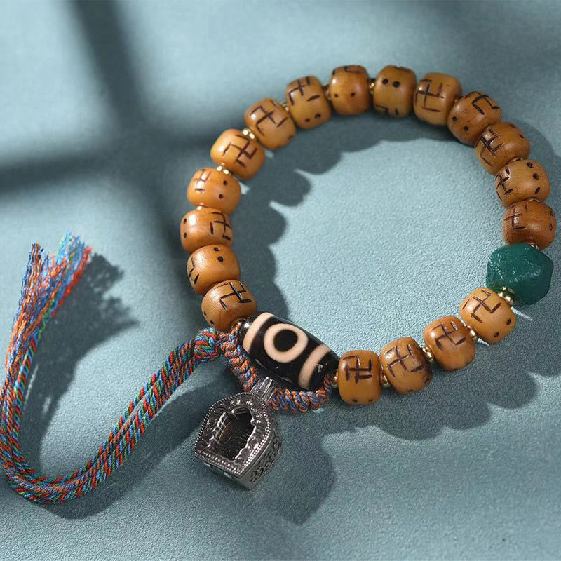 f8ed17dc-642b-45e8-b4be-edefa4a6e4a8 Buddha Stones Natural Tibetan Camel Bone Swastika Dzi Bead Shankha Buddha Charm Kirtimukha Luck Protection Tassel Bracelet - Image 1